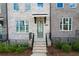 Townhouse front entrance with gray door and brick steps at 5215 Riden Ct, Buford, GA 30518