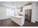 Modern white kitchen with stainless steel appliances and island at 5215 Riden Ct, Buford, GA 30518