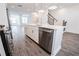 Modern kitchen island with white cabinets, quartz countertops, and stainless steel appliances at 5215 Riden Ct, Buford, GA 30518