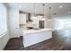 Modern white kitchen with stainless steel appliances and island at 5215 Riden Ct, Buford, GA 30518