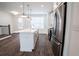 Modern white kitchen with stainless steel appliances and island at 5215 Riden Ct, Buford, GA 30518