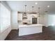 Modern white kitchen with stainless steel appliances and island at 5215 Riden Ct, Buford, GA 30518