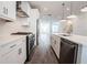 Modern white kitchen with stainless steel appliances and island at 5215 Riden Ct, Buford, GA 30518