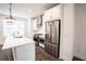 Modern kitchen with stainless steel appliances and white cabinets at 5215 Riden Ct, Buford, GA 30518