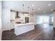 Modern white kitchen with stainless steel appliances and island at 5215 Riden Ct, Buford, GA 30518