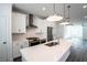 Modern white kitchen with stainless steel appliances and island at 5215 Riden Ct, Buford, GA 30518