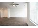 Light-filled living room featuring hardwood floors and a ceiling fan at 5215 Riden Ct, Buford, GA 30518