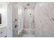 Walk-in shower with marble tile and built-in seat at 5215 Riden Ct, Buford, GA 30518