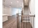 Elegant staircase with wood railing and black balusters at 5215 Riden Ct, Buford, GA 30518