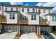 Rear view of townhouses showcasing private decks, garages, and parking area at 5215 Riden Ct, Buford, GA 30518