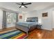 Large bedroom with hardwood floors, ceiling fan, and colorful rug at 1302 Ladd St, Atlanta, GA 30310