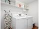 Bright laundry room, washer, dryer, and built-in shelving at 1302 Ladd St, Atlanta, GA 30310