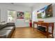 Living room with hardwood floors, neutral walls, and large TV at 1302 Ladd St, Atlanta, GA 30310