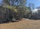 Backyard with mature trees and patchy grass at 3295 Highway 138 Ne, Conyers, GA 30013