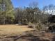 Backyard with patchy grass and winter trees at 3295 Highway 138 Ne, Conyers, GA 30013