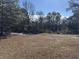 Large backyard with mature trees at 3295 Highway 138 Ne, Conyers, GA 30013