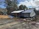 Ranch home with gray siding, red shutters, and a snow-covered roof at 3295 Highway 138 Ne, Conyers, GA 30013