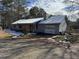 Gray siding ranch home with red shutters and snow on the roof at 3295 Highway 138 Ne, Conyers, GA 30013