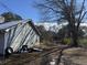 Side of house with tire and debris in yard at 3295 Highway 138 Ne, Conyers, GA 30013