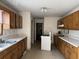 Kitchen with wood cabinets, white appliances, and tiled floor at 3295 Highway 138 Ne, Conyers, GA 30013