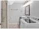 Bathroom including a vanity with modern sink, mirror, shower with glass door, and a washer and dryer at 6851 Roswell Rd # J1, Atlanta, GA 30328