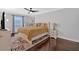 Bedroom with wood floors, blue accent pillows and a ceiling fan at 6851 Roswell Rd # J1, Atlanta, GA 30328