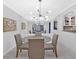 Bright dining room with modern light fixture, mirrored wall and a view into the kitchen at 6851 Roswell Rd # J1, Atlanta, GA 30328