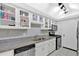 Kitchen with granite countertops, white cabinets, and stainless steel appliances at 6851 Roswell Rd # J1, Atlanta, GA 30328