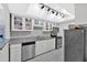 Kitchen with granite countertops, white cabinets, and stainless steel appliances at 6851 Roswell Rd # J1, Atlanta, GA 30328