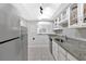 Modern kitchen features stainless steel appliances, and a pass through to the dining area at 6851 Roswell Rd # J1, Atlanta, GA 30328