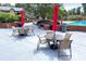Community pool with lounge chairs, tables, umbrellas, barbecue grills and lush landscaping at 6851 Roswell Rd # J1, Atlanta, GA 30328