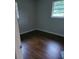 Simple bedroom with dark hardwood floors and window at 794 Old Allatoona Se Rd, Cartersville, GA 30121