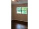 Bright bedroom with dark hardwood floors and a window at 794 Old Allatoona Se Rd, Cartersville, GA 30121