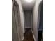 Long hallway with dark hardwood floors and doors to bedrooms at 794 Old Allatoona Se Rd, Cartersville, GA 30121