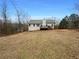 Large backyard with a deck and wooded area at 85 Kristen Pl, Covington, GA 30016