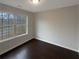 Well-lit bedroom with hardwood floors and large window at 85 Kristen Pl, Covington, GA 30016