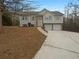 Two-story house with a two-car garage and a landscaped yard at 85 Kristen Pl, Covington, GA 30016