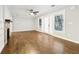 Spacious living room featuring a brick fireplace, hardwood floors, and large windows at 1624 Venetian Sw Dr, Atlanta, GA 30311