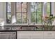 Kitchen sink with dark countertops and windows overlooking the backyard at 2305 Sherbrooke Ne Dr, Atlanta, GA 30345