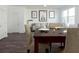 Dining room with dark wood table and tan chairs, near living room at 334 Naples Dr, Locust Grove, GA 30248