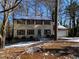 Two-story house with brown and beige siding, attached garage, and snowy yard at 5174 Stone Trce, Stone Mountain, GA 30083