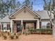 Craftsman style home with brick and siding exterior, front porch, and landscaping at 1045 Brook Knoll Ln # 401, Cumming, GA 30041