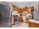 Kitchen with wood cabinets, stainless steel appliances, and ample counter space at 1214 Overton Dr, Lawrenceville, GA 30044