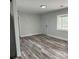 Living room featuring grey wood-look flooring and an exterior door at 132 Lamar Nw Ave, Atlanta, GA 30314