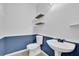 Bathroom featuring tile flooring, floating shelves, and a pedestal sink at 148 Shady View Pl, Lawrenceville, GA 30044