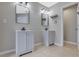Well-lit bathroom features two light gray vanities, dark hardware and mirrors at 148 Shady View Pl, Lawrenceville, GA 30044