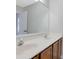 Bathroom featuring a long vanity with double sinks and wood-look cabinetry at 148 Shady View Pl, Lawrenceville, GA 30044