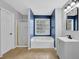 Bathroom with a tub and shower, single vanity, and a window providing natural light at 148 Shady View Pl, Lawrenceville, GA 30044