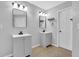 Bathroom featuring double vanities, tile floor, and well-lit mirrors at 148 Shady View Pl, Lawrenceville, GA 30044