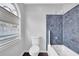 Bathroom featuring a tub/shower, toilet, and window at 148 Shady View Pl, Lawrenceville, GA 30044